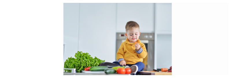 young child eating new fruit and veg